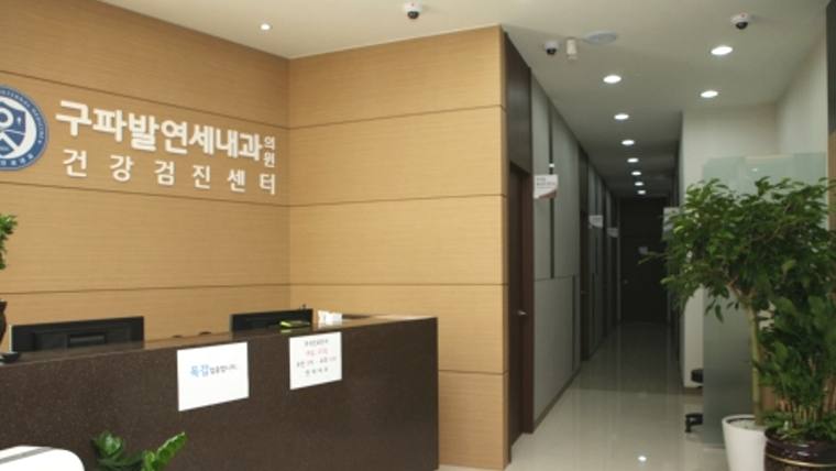 구파발연세내과의원 — 병원의 접수대와 내과 병원명이 적힌 벽면, 그리고 복도로 이어지는 입구가 보이는 실내 전경